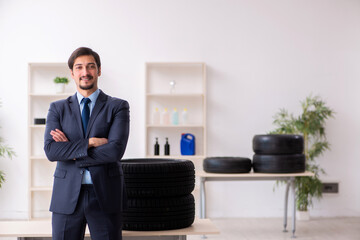 Young man selling tires in the office