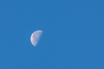 Natural phenomenon, Half moon in daytime with blue clear sky, A completely normal occurrence in...