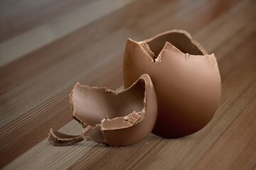 Stuffed sweet chocolate easter egg on a wood table