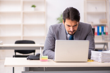 Young male employee working in the office