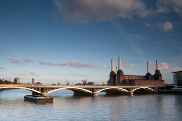 Fototapeta na wymiar Thames River Grosvenor Rail Bridge Battersea Power Station blue sky white clouds