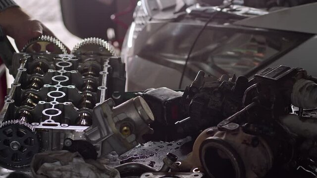 Car Master Checks Camshaft Of Car Engine In Repair Shop