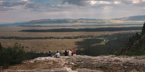 people on a mountain looking out
