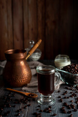 Obraz na płótnie Canvas coffee in fresh beans with cup of coffee and old coffee pot with dark wooden background and dark style sugar bowl