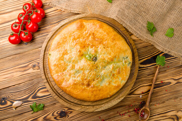 khachapuri with spinach and cheese on the board, georgian cuisine top view