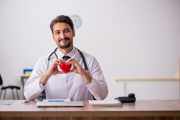 Young male doctor cardiologist working in the clinic