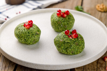 pkhali of spinach, georgian cuisine on white plate on wooden table
