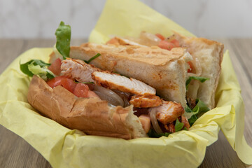 Loaded Tikka chicken sub sandwich bursting with fillings in a freshly baked bun