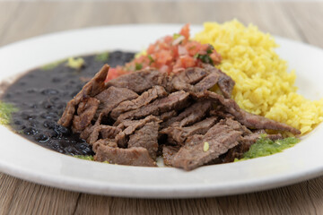 Complete grilled tikka steak meal sliced up with rice and salad for a hearty appetite