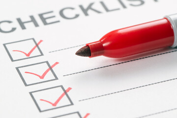 Red marker pen marking on checklist box, close up