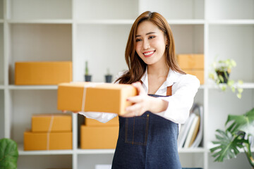 Portrait of Starting small businesses SME owners female entrepreneurs working on receipt box and check online orders to prepare to pack the boxes, sell to customers, SME business ideas online.