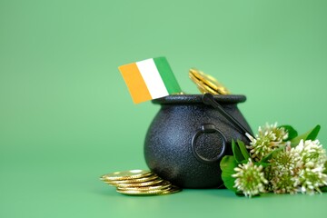St.Patrick 's Day background . flag of Ireland, bowler hat with gold coins, bunch of clovers on a...