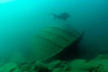 Diver exploring a Great Lakes tugboat shipwreck found in Lake Superior
