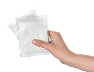 Female hand with menstrual pads on white background