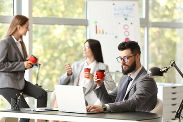 Business people having coffee break in office