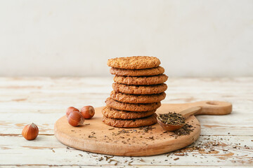 Wooden board with tasty hojicha cookies on table