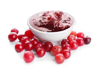 Bowl of tasty cranberry jam and fresh berries on white background