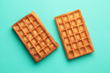 Tasty homemade Belgian waffles on color background