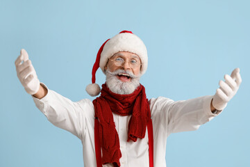 Fototapeta na wymiar Portrait of happy Santa Claus on color background