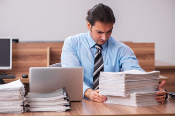 Young male employee unhappy with excessive work