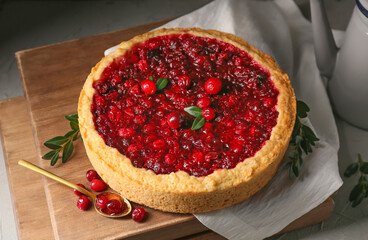 Boards with delicious lingonberry pie on table