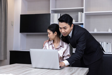 A Boss touching the shoulder of employee colleague in workplace at office.