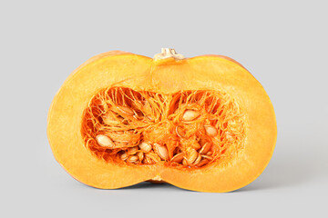 Half of ripe pumpkin on light background