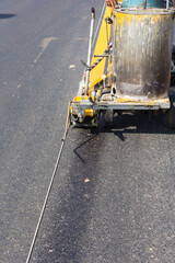 Machine eject and worker on road and traffic sign painting