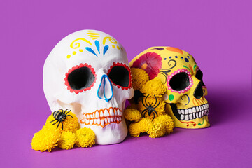 Painted human skulls with flowers on violet background. Mexico's Day of the Dead (El Dia de Muertos)