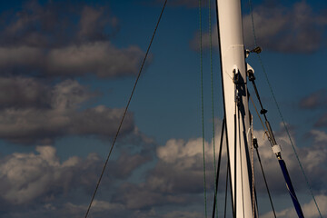 Sailboat mast rigging on a cloudy sky
