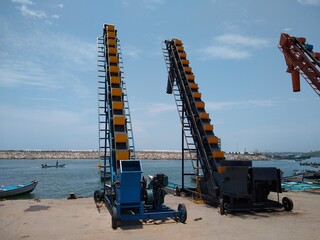 Ice crusher machine and conveyor, Thengapattanam fishing harbor, Kanyakumari district, Tamilnadu, seascape view