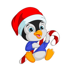 Cute little penguin in santa hat holding candy