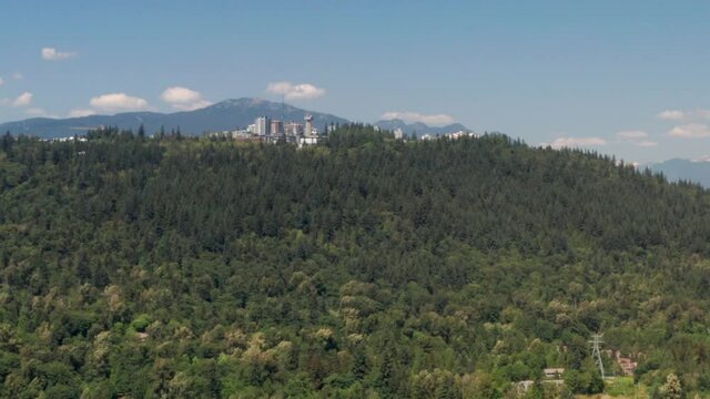 Simon Fraser University Surrounded By Lush Green Forest In The Burnaby Mountain  In Canada - aerial shot