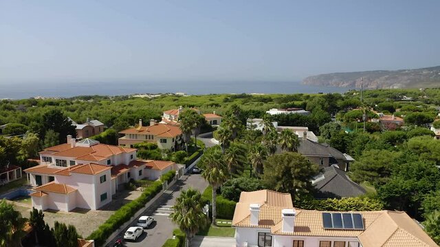 Aerial view over a rich homes at the residential area, in Quinta da Marinha, Lisbon - reverse, drone shot