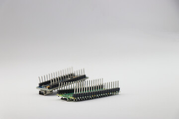 Pins of microcontroller board isolated on white, Header pins of circuit board side view