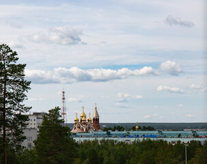 View of the church from the central park of the city of Noyabrsk in summer