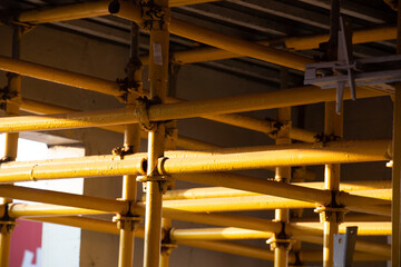 Yellow steel reinforcement bracket on construction site