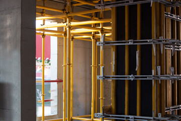 Yellow steel reinforcement bracket on construction site