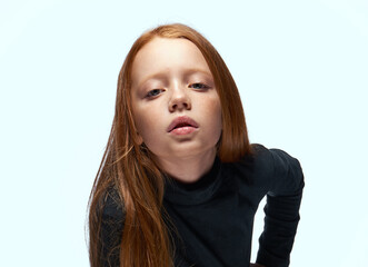 red-haired girl in a black sweater planning close-up