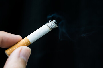 Hand holding a cigarette.World No Tobacco Day Concept Stop Smoking.