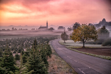 beautiful sunrise over a swiss village and the church 