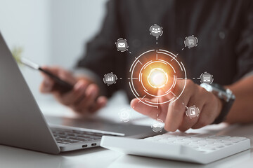 In the office, a businessman uses a smartphone, laptop, and digital tablet computer with digital marketing media in a virtual icon.