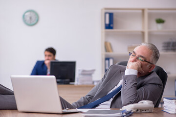 Two male employees working in the office