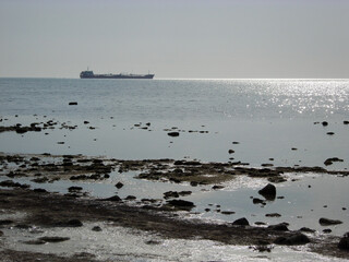 Silhouette of a ship at sea.
