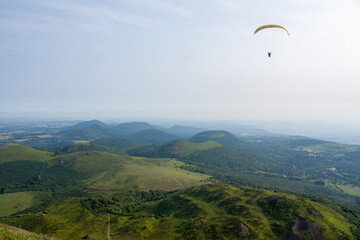 paraglider are flying in the valley. - obrazy, fototapety, plakaty