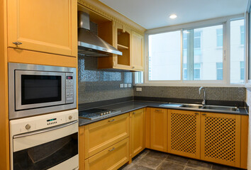 Compact kitchen interior with wooden cabinets