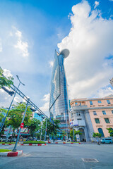 Fototapeta premium Ham Nghi Street in Ho Chi Minh, Vietnam. Scooter traffic in Saigon tourist district with Bitexco Financial Tower in background.