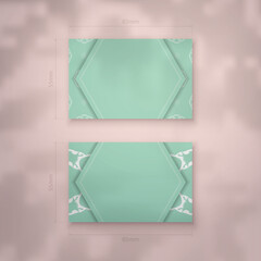 Mint color business card with mandala white ornament for your personality.