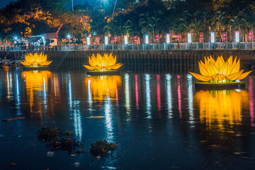 Floating colored lotus lanterns on river at night on Vesak day for celebrating Buddha's birthday in...