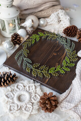 Christmas wreath, made on a wooden board with threads using string art technique, beautiful New Year's decor, handmade